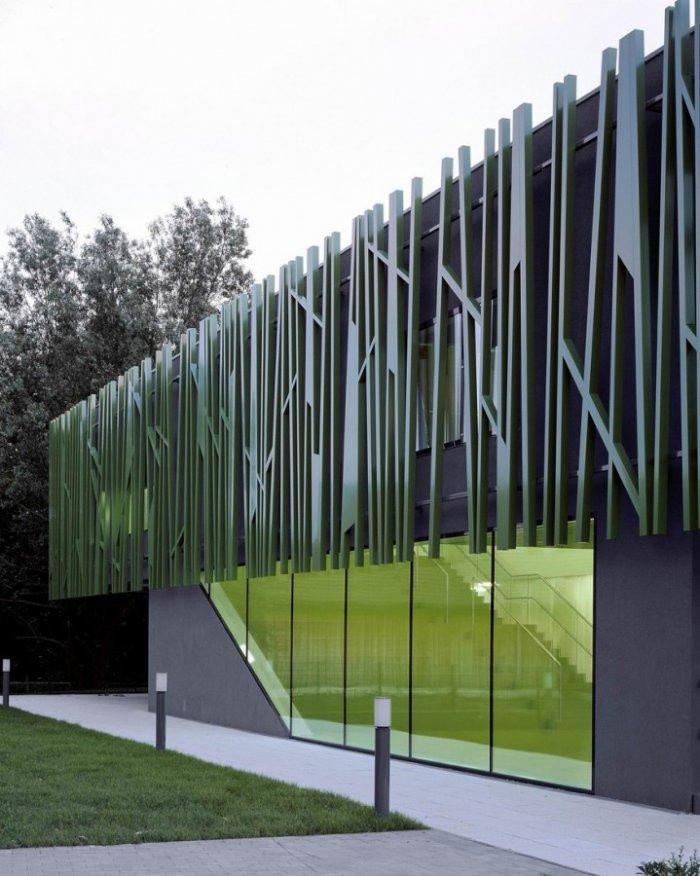  The modern facade of the building combines glass and other solid materials.