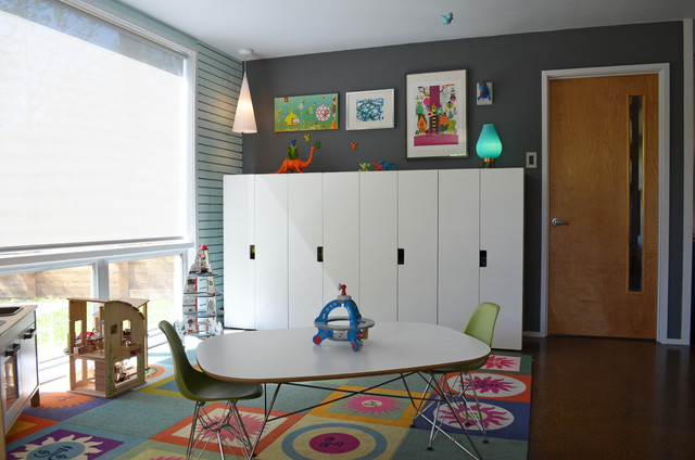 The kids room with a table and chairs in the middle and toys spread around - Eclectic Dallas Home with Mid-Century Interior Design