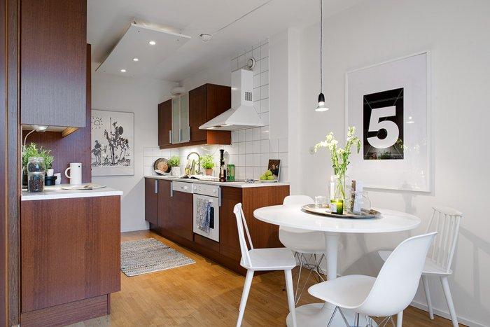 A view towards the open kitchen and the dining area - Scandinavian Small Apartment Interior Design in Gothenburg