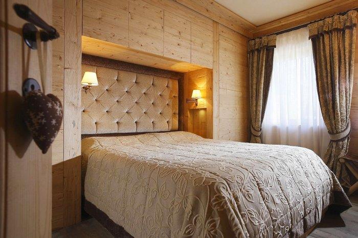 Bedroom with wooden walls - Wooden interior design of an apartment in a rustic style