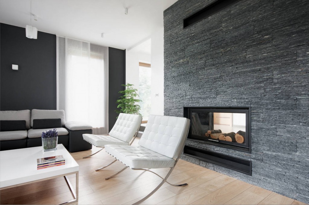 Living room with white comfortable chairs in a Contemporary Family House in Poland with Minimalist Touch