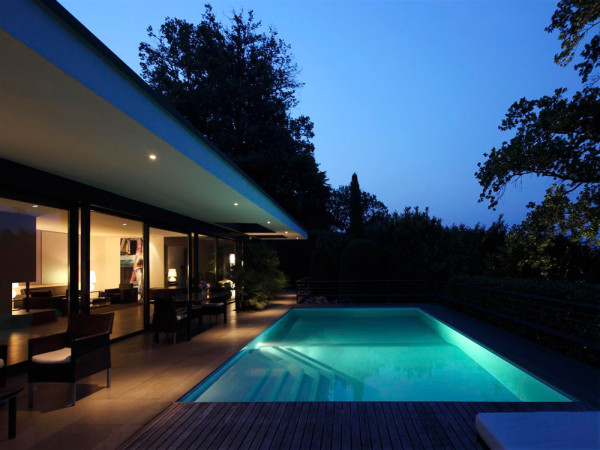 Luxury villa with swimming pool by night - Minimalist Design by Bruno Klauser