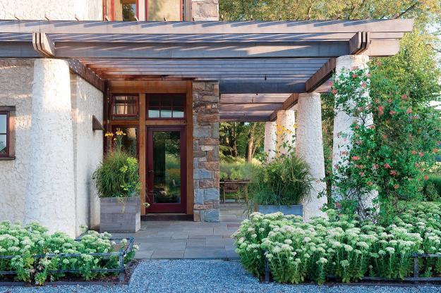 The main entrance of the sustainable house with Beautiful Outdoor Garden Areas