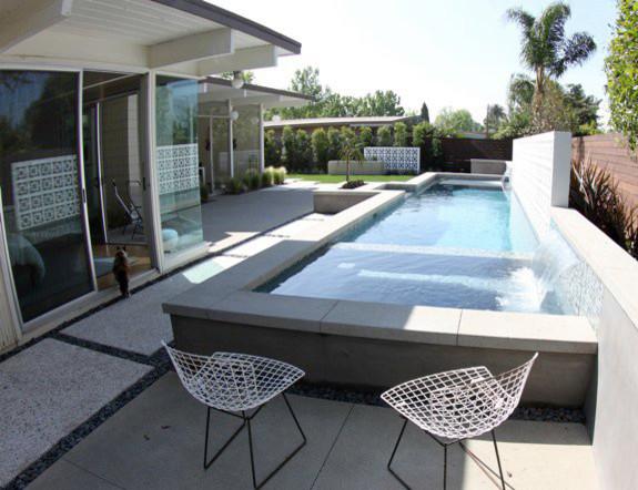 Two modern chairs in front of a swimming pool - Contemporary Garden and Patio Furniture Arrangement Ideas