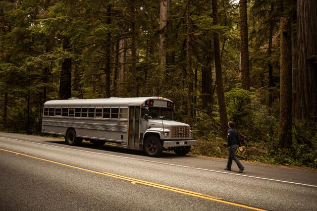 Modern Holiday Mobile Cabin in a Old school bus on a road