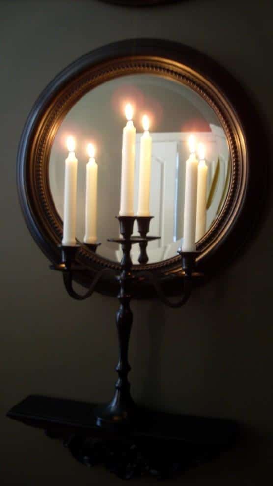 Candleholder with candles in front of a mirror - Spooky Halloween Ideas for Scary Interior Decorations