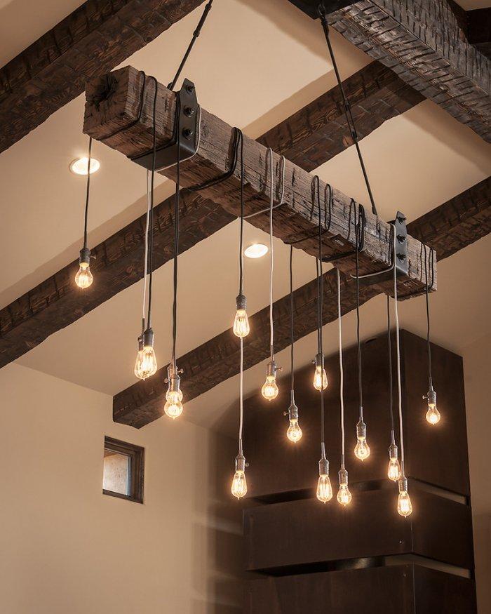 Contemporary hanging lighting and wood barn beams - Luxury Rustic Family Desert House in Arizona