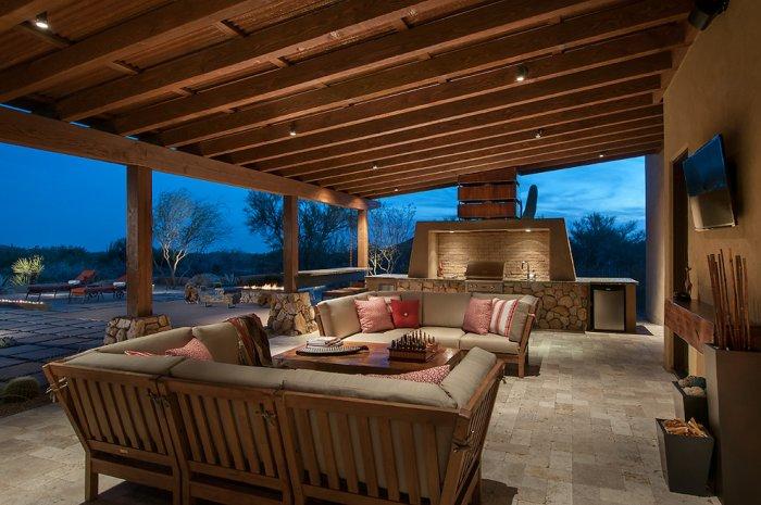 Open kitchen with barbecue area and comfortable patio furniture in a Luxury Rustic Family Desert House in Arizona