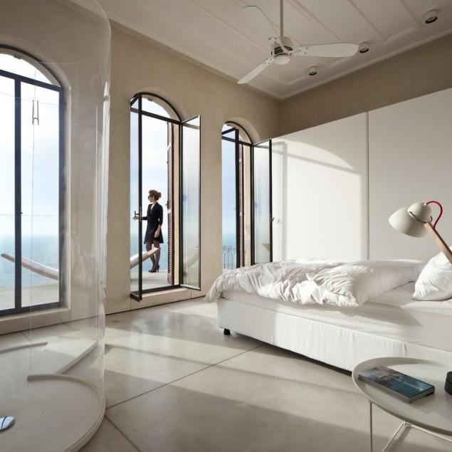 spacious bedroom design wit ha touch of white an transparent shower: Spectacular Ancient Seaside Penthouse in Tel Aviv