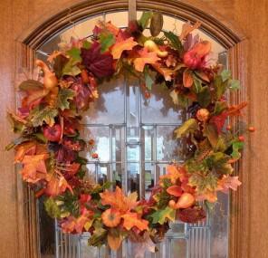 Front door with beautiful fall wreath in orange colors - 9 Easy DIY Decorating Ideas with Autumn Leaves