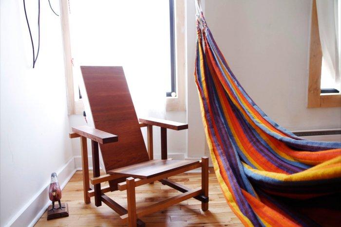 Hand-made wooden armchair and a colorful hammock - Living in a Romantic Apartment in Montreal