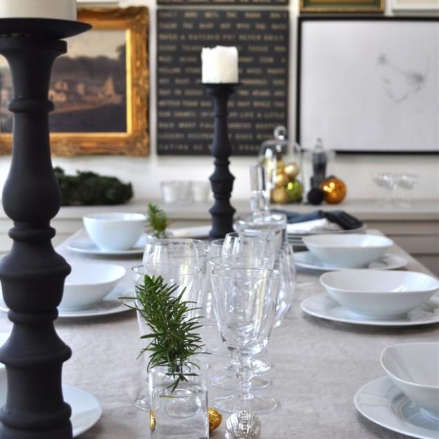 A Christmas table decorated with tree branches, silver balls and candleholders - 17 Scandinavian Examples of Home Decorations