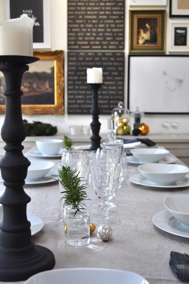 A Christmas table decorated with tree branches, silver balls and candleholders - 17 Scandinavian Examples of Home Decorations