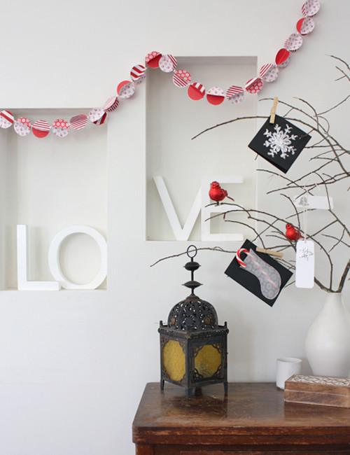 Tree branches decorated in lovely red ornaments and cards - 17 Scandinavian Examples of Home Decorations