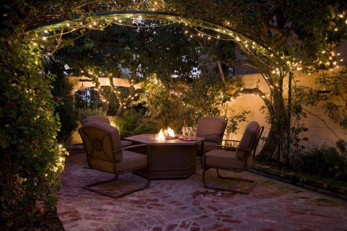 String lights wrapped around an archway of vines - Casual Christmas Decoration