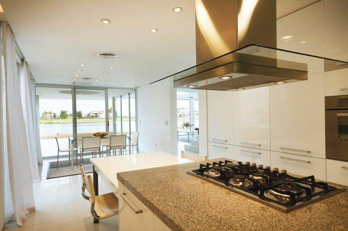 The contemporary kitchen has a nice view - House in Buenos Aires by Alejandro Amoedo