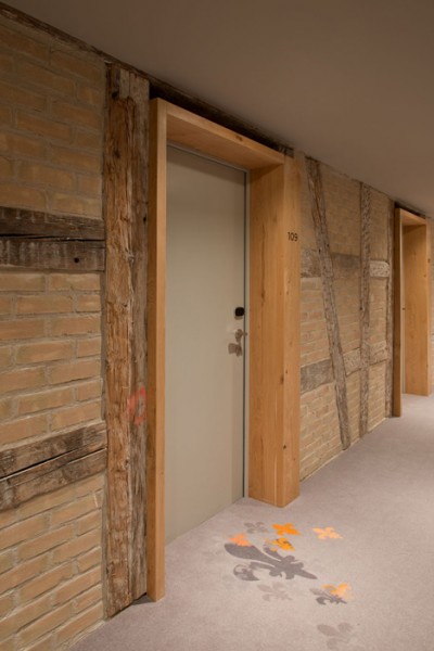 Rough wooden accents for the room doors - trendy commercial interior design with wooden accents