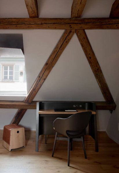 Small working desk inside a rustic room - trendy commercial interior design with wooden accents