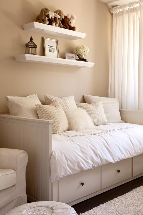 Kids room with a comfortable sofa and toys on the shelves above