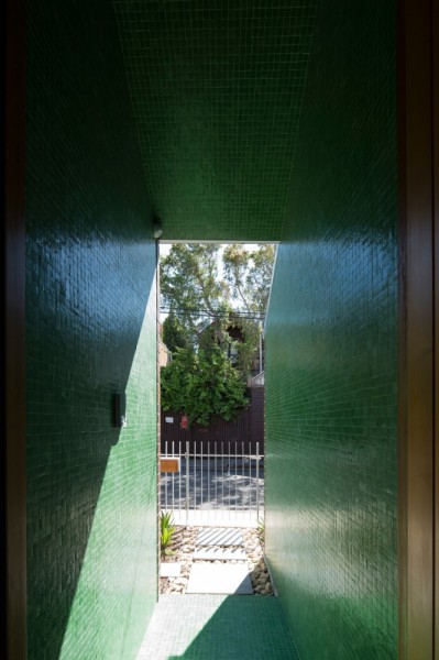Narrow green hallway leading outdoors
