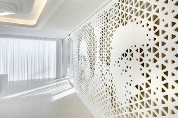 Perforated_walls_with_portraits-Modern Bank Interior Design - Raiffeisen in Zurich