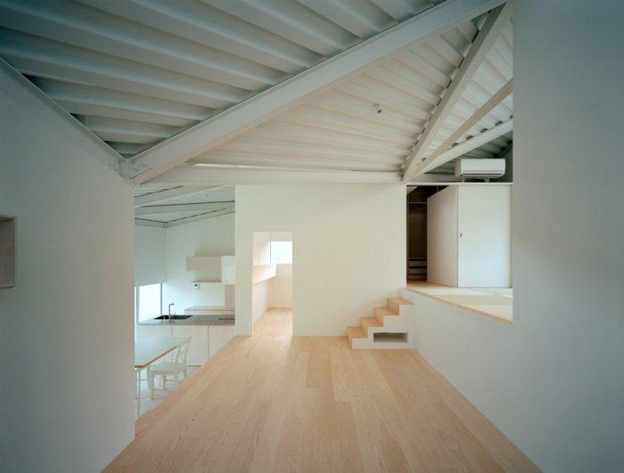 Small minimalist house with wooden flooring and white walls