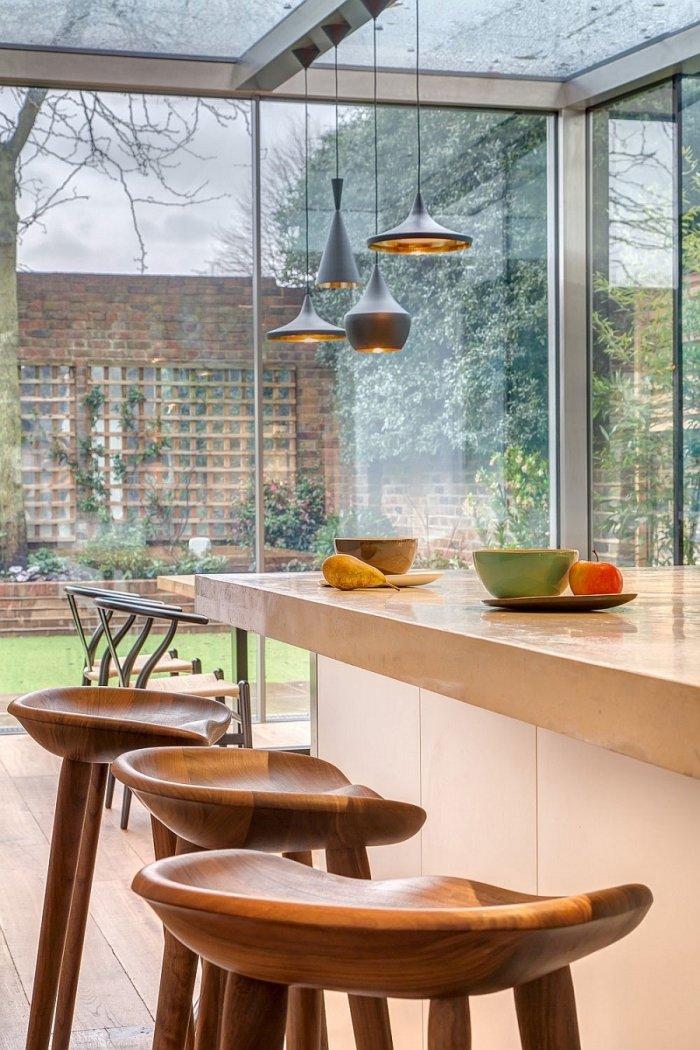 Bar stools made of wood and placed at the kitchen island