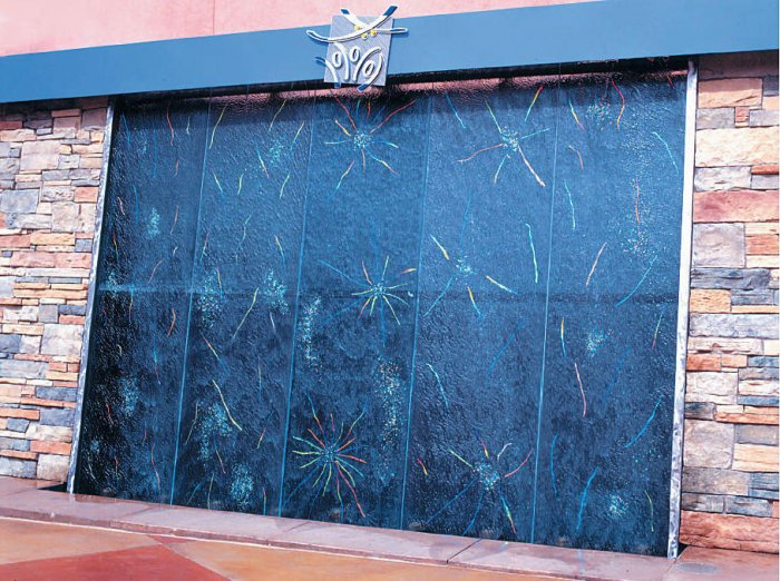 Colorful glass wall exposed outside at a brcik wall