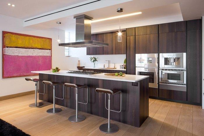 Contemporary penthouse kitchen with dark cabiners and long island