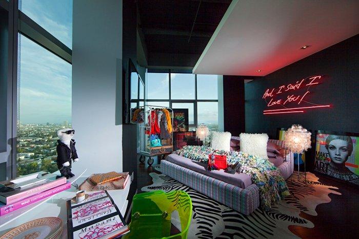 Eclectic bedroom with neon wall sign and amazing views