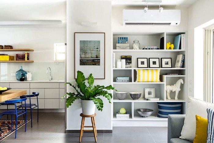 Eclectic corner with white shelves and abstract paiting on the wall