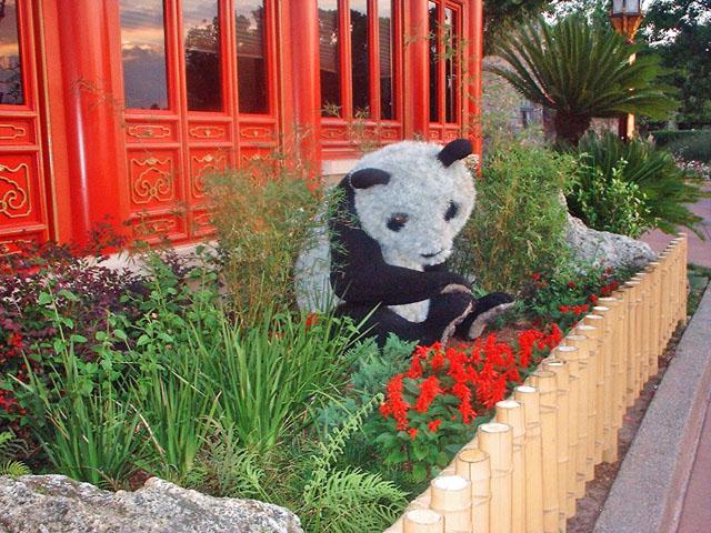 Garden art sculpture - little panda among the flowers