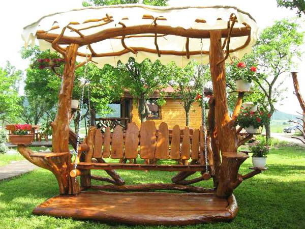 Garden swing with designed sunshade and flower pots