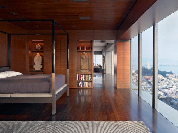 Guest bedroom inside the high-rise apartment with beautiful views over the city