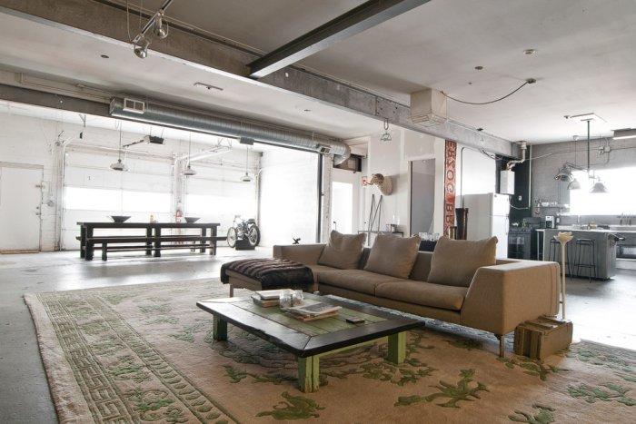 Industrial living room with rustic small table and giant carpet