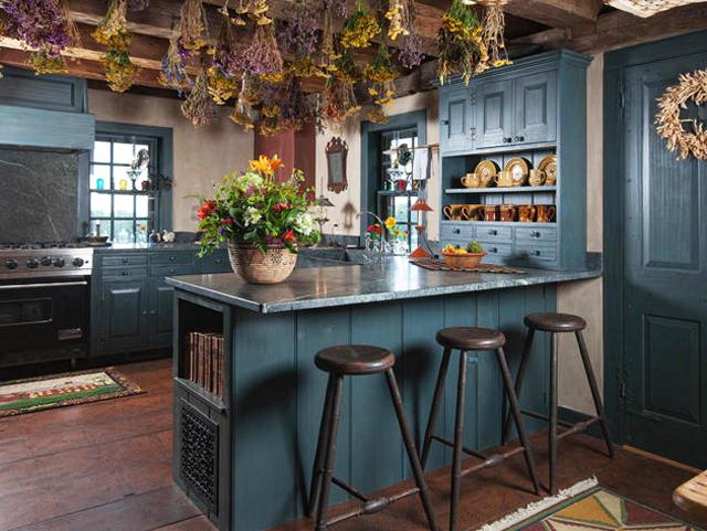 Kitchen design in rustic style with dark green walls and island