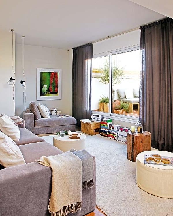 Living room with soft grey furniture and glass sliding door leading to terrace