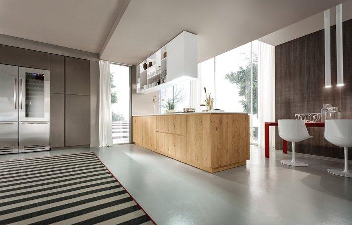 Minimalist kitchen in white with wooden doors on the island drawers