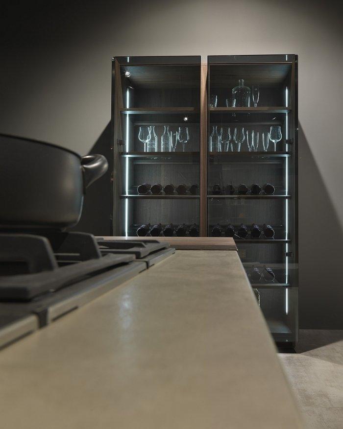 Modern kitchen with cupboard for wine bottles collection and wine glasses