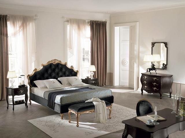 Modern traditional bedroom with light colored walls and black bed and furniture