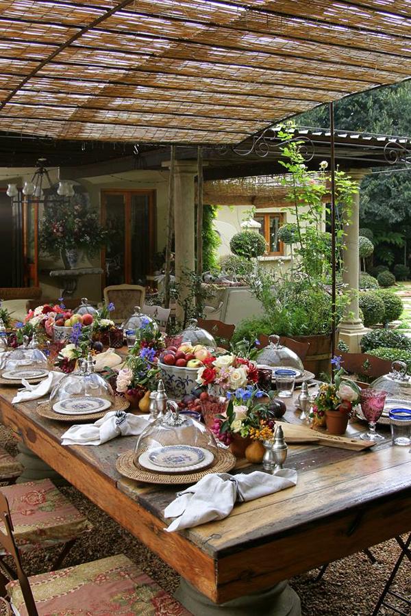 Outdoor rustic table under a wide pergola made of wood