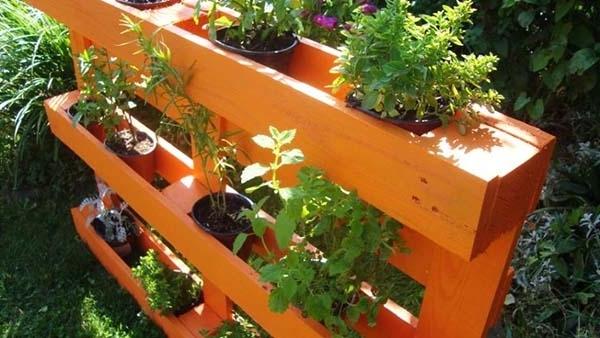 Pallet furniture used as flower pot rack in the garden
