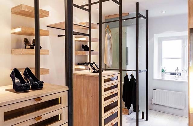 Scandinavian clothes storage room with wooden shelves for shoes and clothes