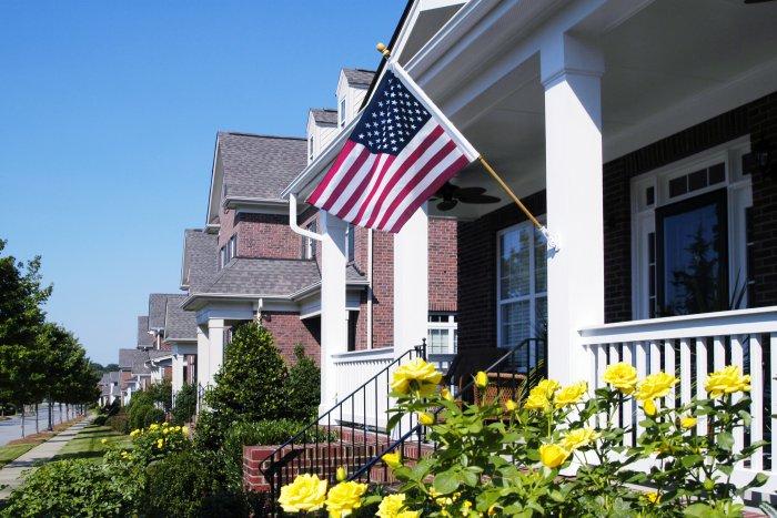  American  flag  on the front porch of a house  in white Founterior