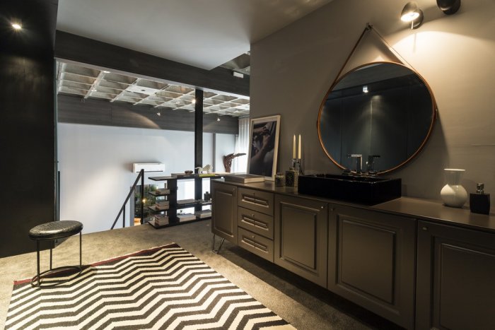 Contemporary bathroom with graphic rug and stylish traditional cabinets