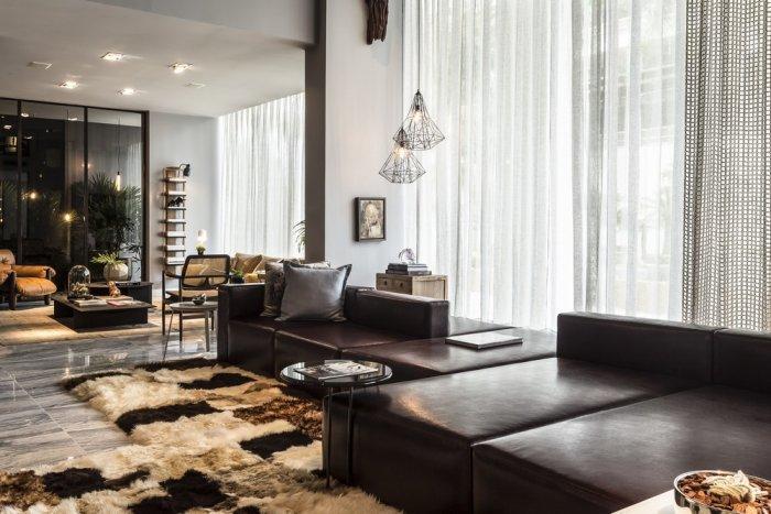 Contemporary loft living room with luxury brown leather sofas and expensive rug