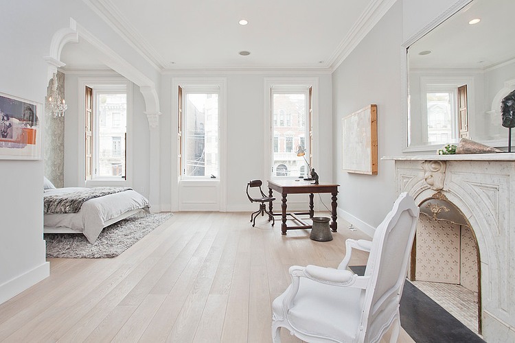 Eclectic bedroom in white with fireplace