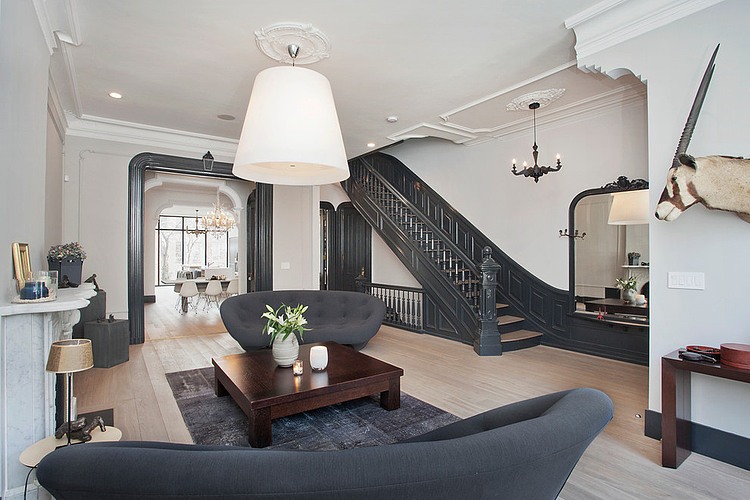 Eclectic living room with white walls and dark furniture