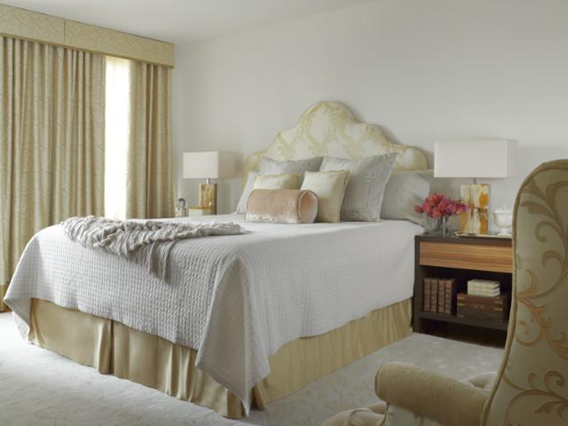 Feminine bedroom design with comfortable bed in pale mild color tones