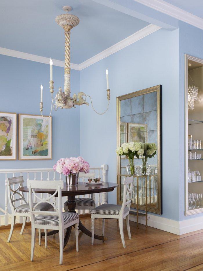 Feminine dining room in traditional style with pale blue walls